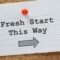 The words Fresh start this way on lined paper on a bulletin board.