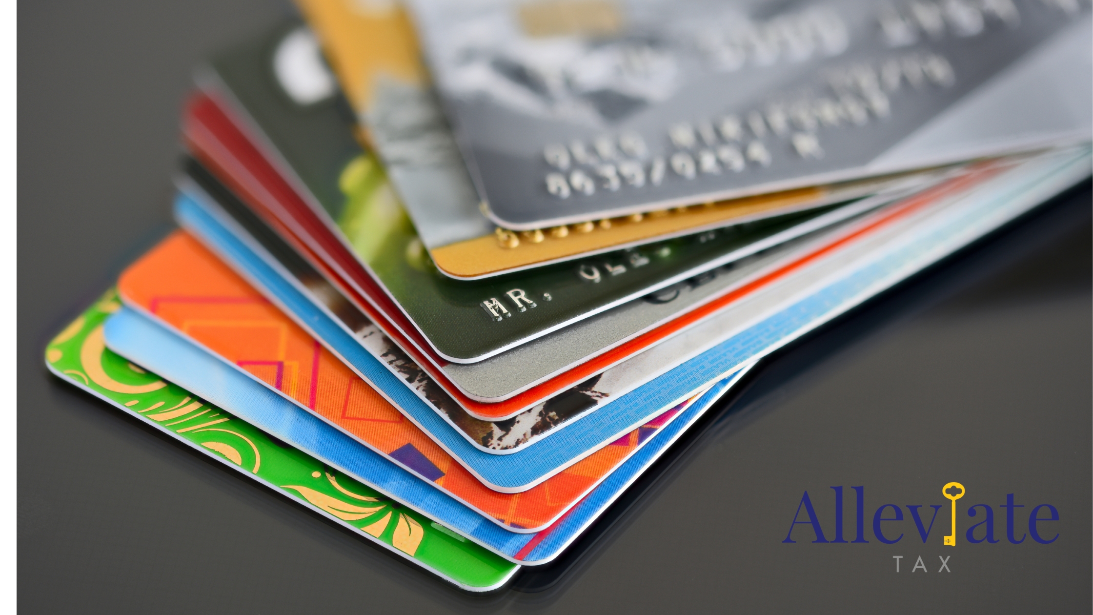 Pile of credit cards against a gray background