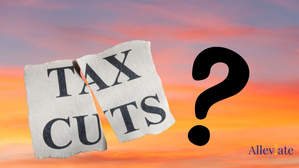 the words tax cuts, cut in half on paper and a question mark against a sunset background, indicating the tax law sunset 2025