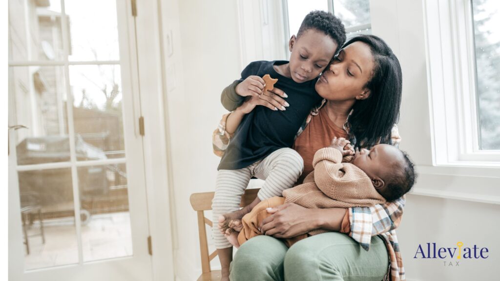 mom with a toddler and an infant on her lap